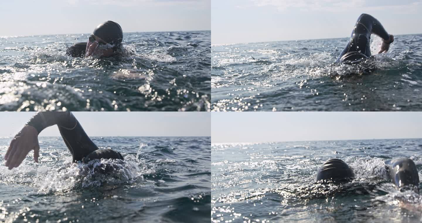 SLO-MO开放水域游泳者在海上游泳，在阳光下爬行