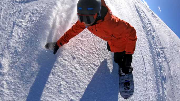 在一个阳光明媚的冬日，一名男子在滑雪场的滑雪坡上滑雪