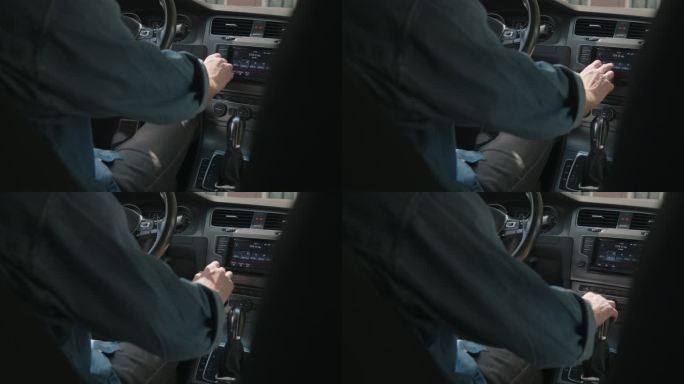 汽车司机在其主机屏幕上切换无线频道