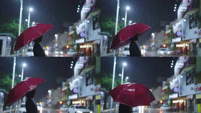 雨中，一个亚洲女人撑着伞。