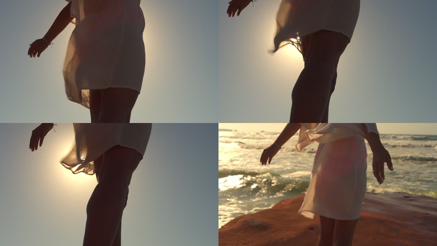 一位年轻女子在海滩上张开双臂享受微风