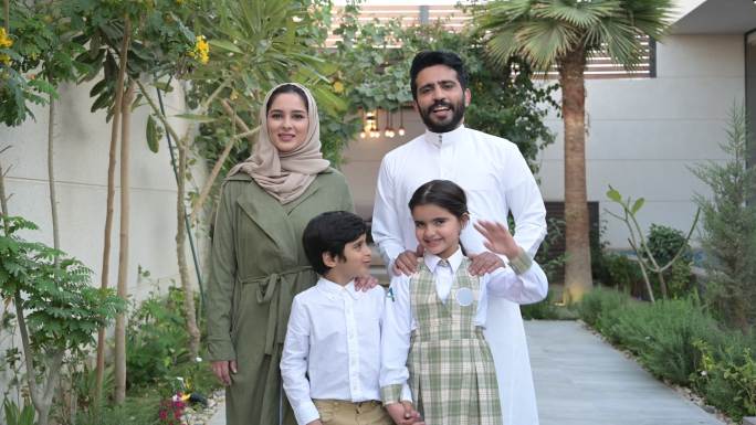 站在家门口的沙特年轻家庭肖像