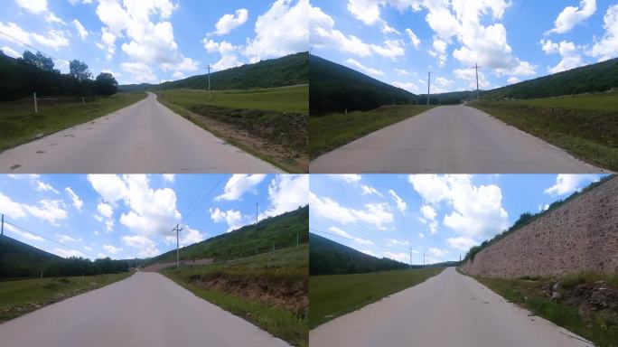 行驶蓝天白云绿树绿草的山路中 第一视角