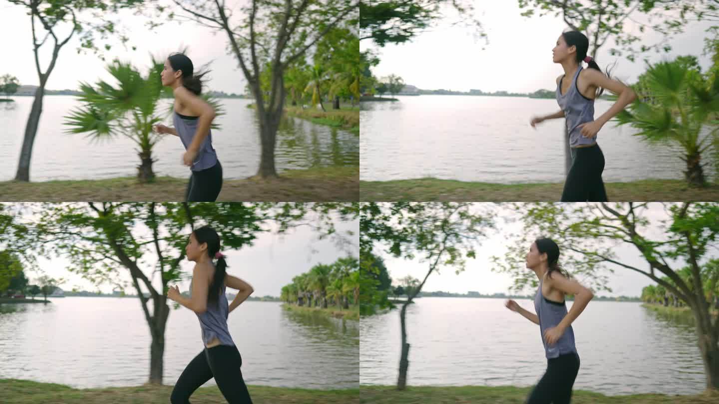 亚洲女人在户外锻炼，她在跑步