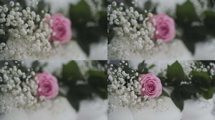 粉红玫瑰婚礼花束，白色桌面背景