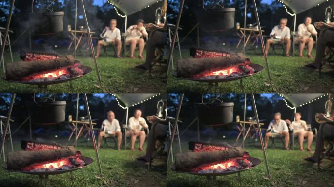 亚裔中国家庭露营晚餐，篝火上方的大锅，柴火冒着烟和热沸腾