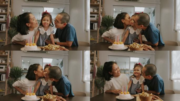 泰国父母在家里的生日派对上亲吻他们的女孩。
