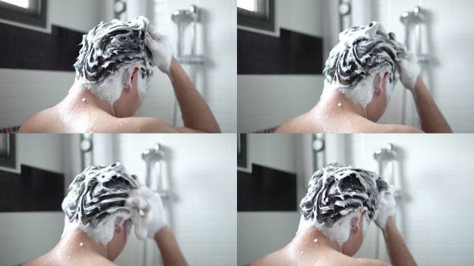 一名亚洲男子正在浴室里洗头发和沐浴露。