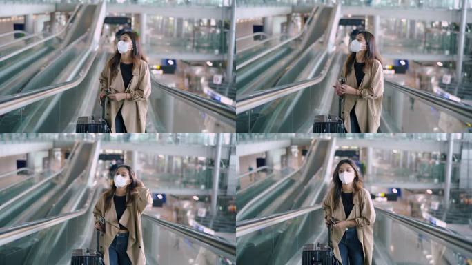 旅客戴着口罩在智能手机上检查登机牌。