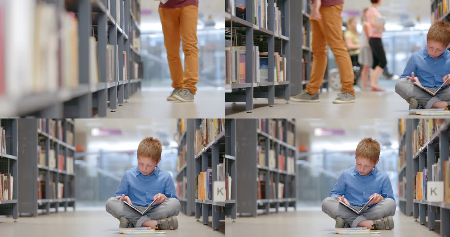 坐在图书馆过道上看书的小男孩