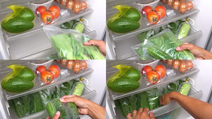 一个人正在把蔬菜放进冰箱。