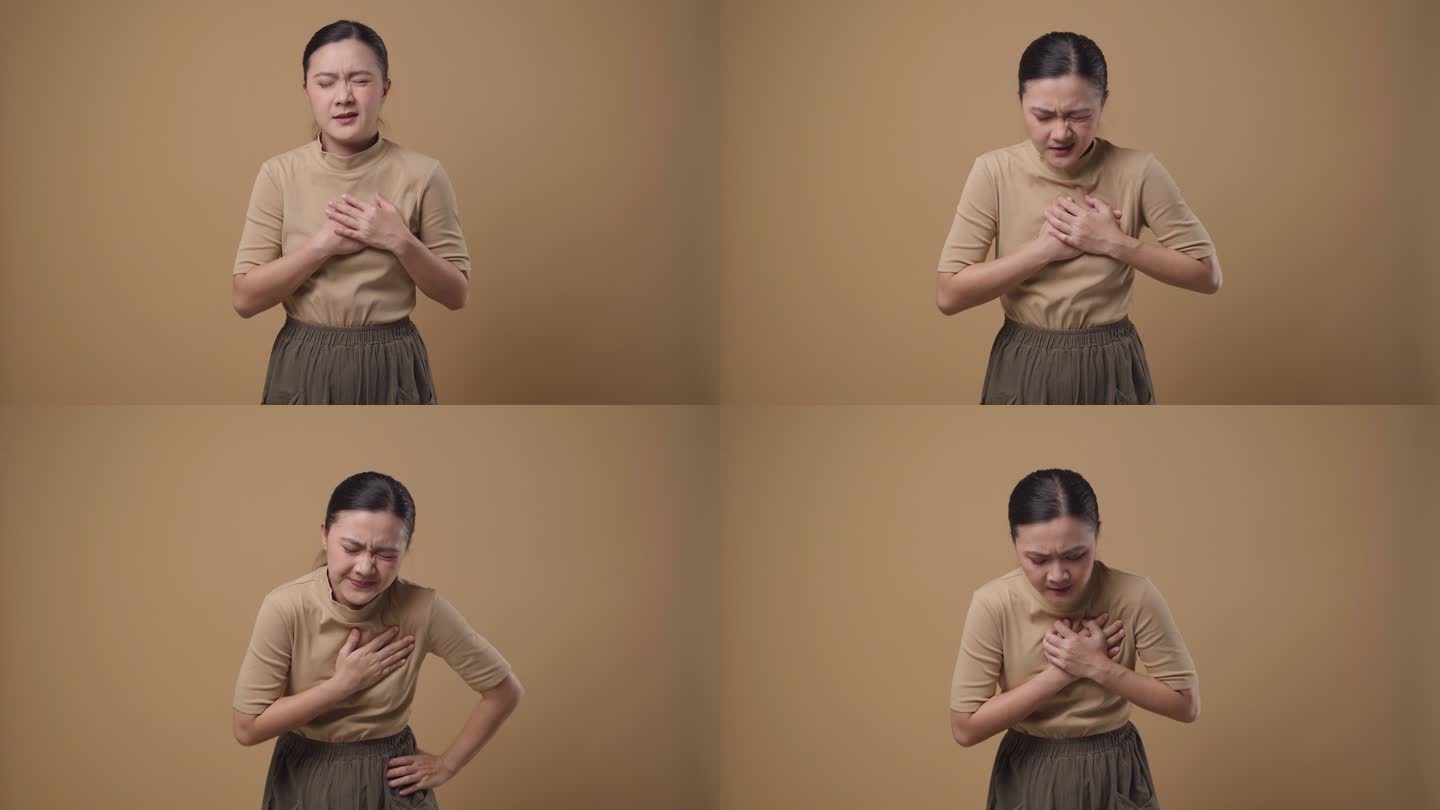 一位亚洲女性胸痛是孤立的背景。4K视频