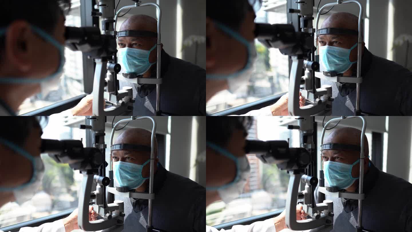 验光师戴着防护面罩检查病人的眼睛