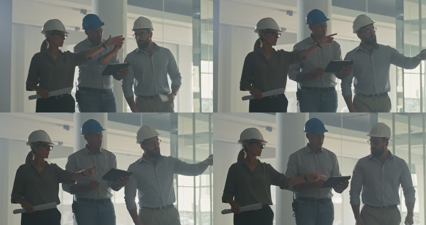 一组建筑师或工程师同事在团队建设项目中使用数字平板电脑。会议期间，男人和女人在网上查看建筑计划的蓝图