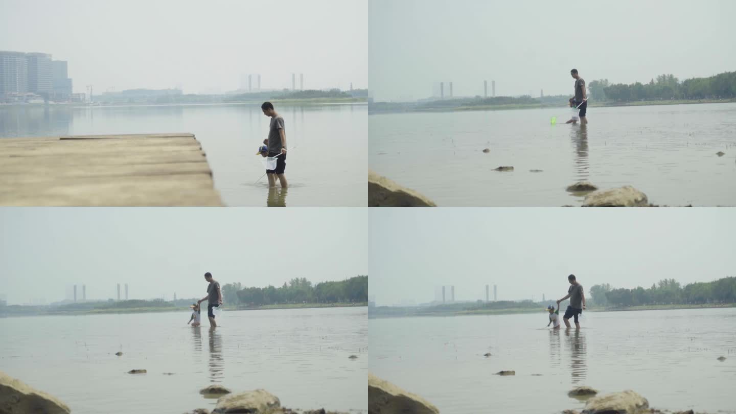 父亲带着孩子在河里捕鱼游玩亲子父子
