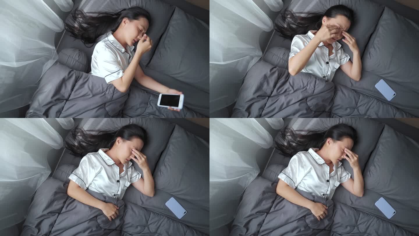 一名亚洲妇女早上躺在床上，眼睛疼痛。俯视图。