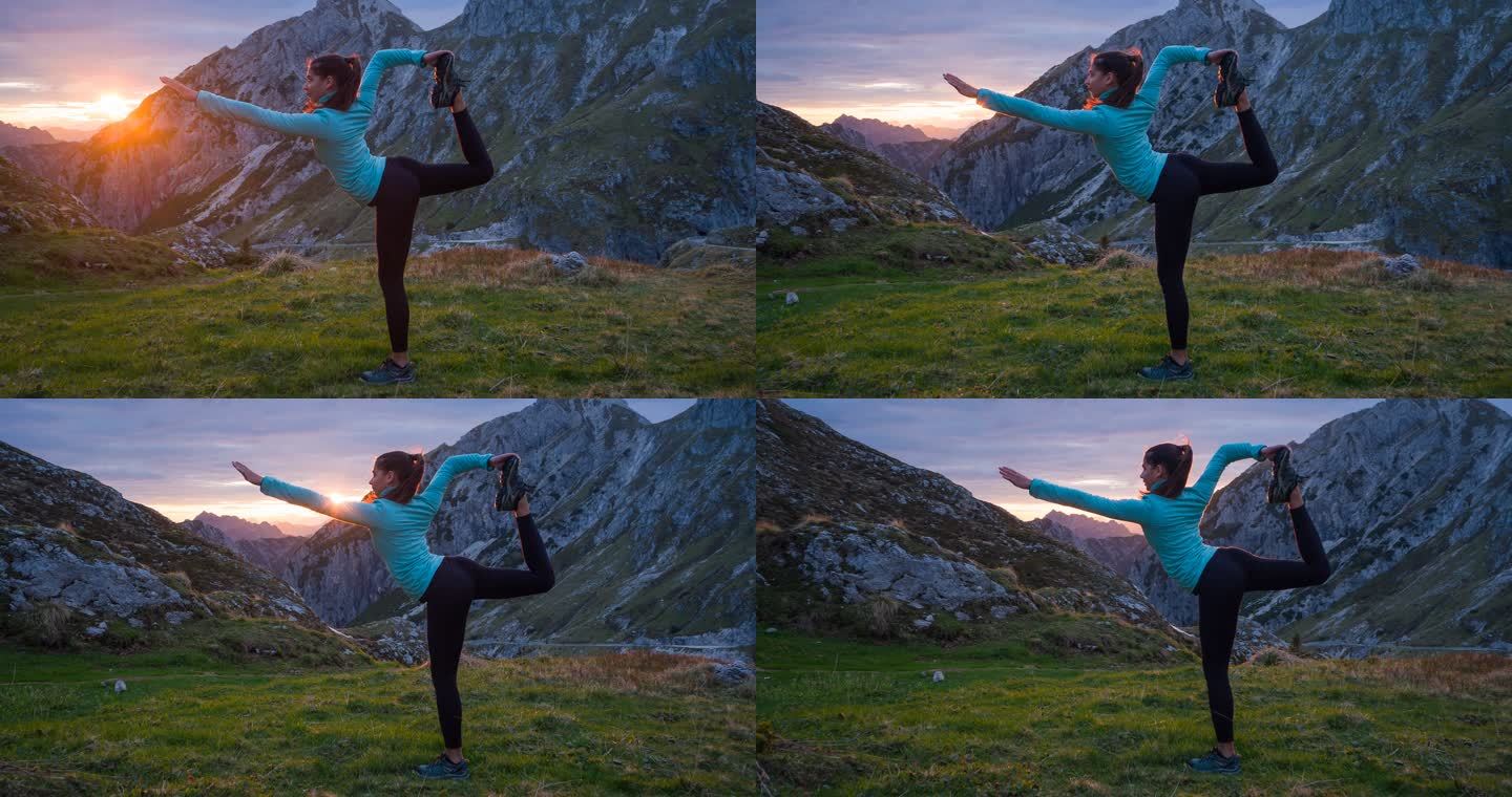 有身体意识的女人在日出时在山上做瑜伽姿势