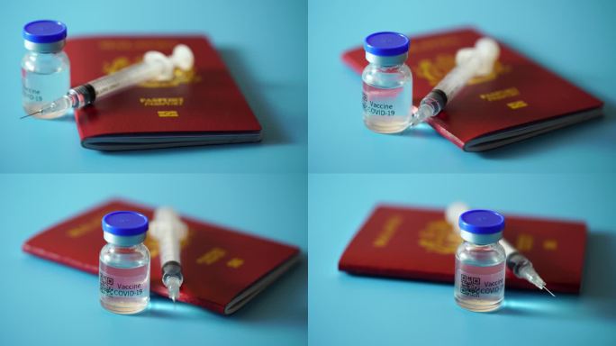 疫苗接种和旅行的概念。一瓶新冠疫苗、注射器和护照。