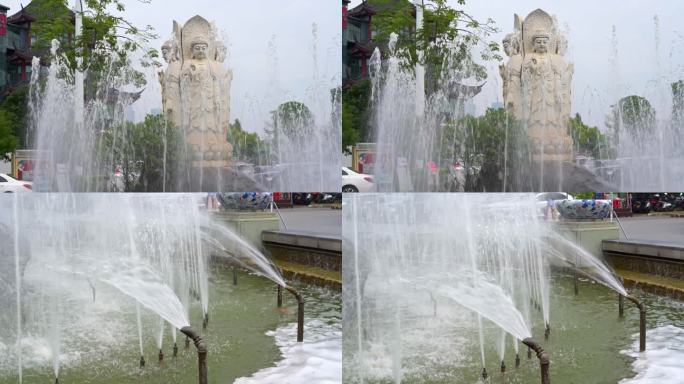 观音石雕像摆在中间的喷泉水池