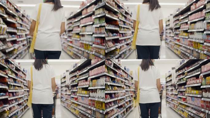 亚洲年轻女子使用可重复使用的袋子在超市购物