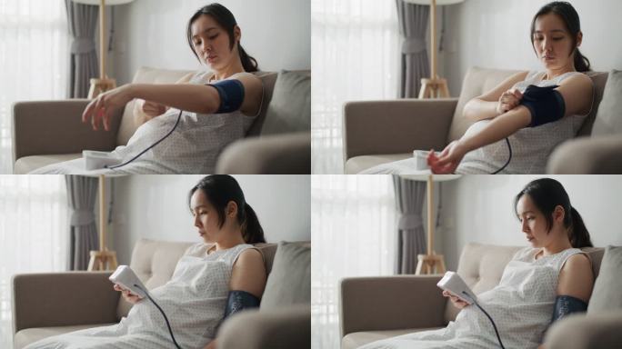 年轻孕妇使用数字测量设备检查血压