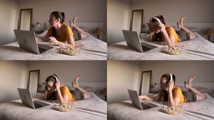 一个精力旺盛的女人躺在床上看笔记本上的视频流。