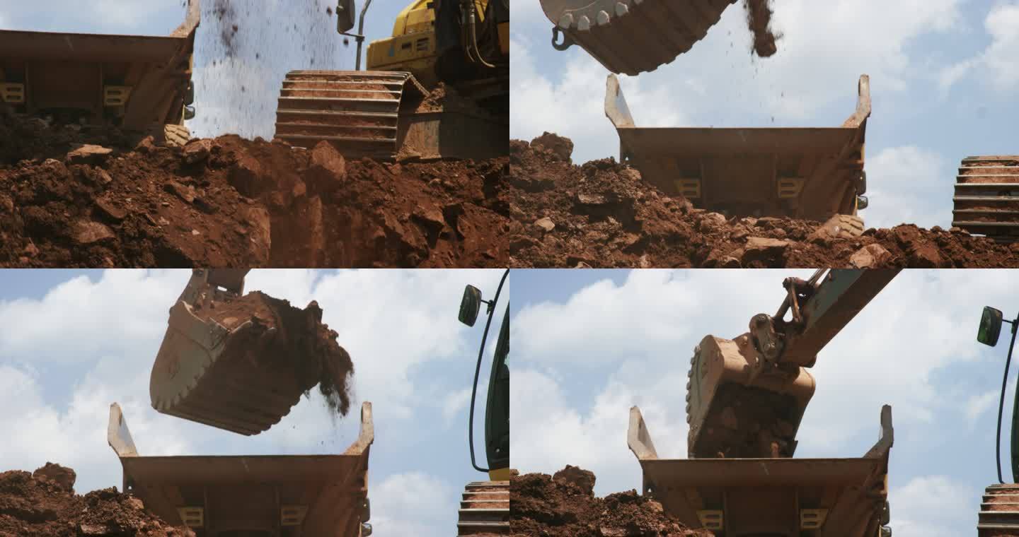 在阳光明媚的建筑工地，挖掘机铲斗挖掘、捡起泥土并将其倒入自卸车后部的慢镜头
