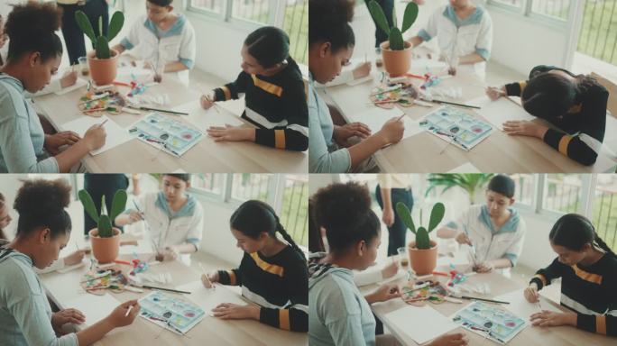 美术老师在水彩画课上教他的小学生