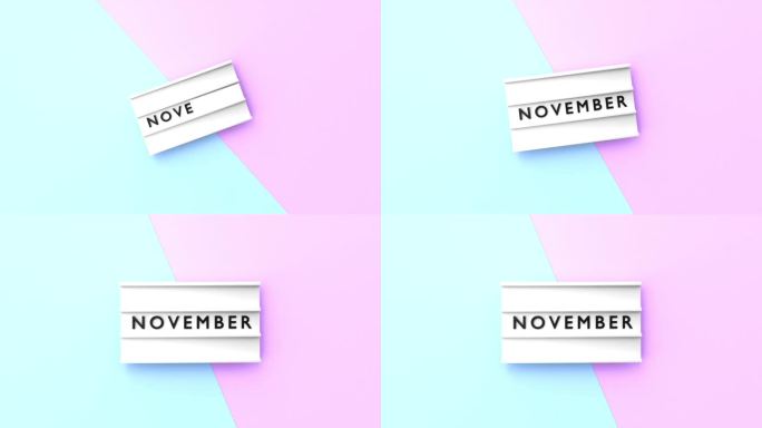 11月文本以4K分辨率显示在蓝色和粉红色背景的灯箱上