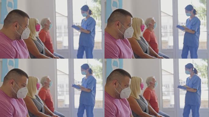 人们坐在接种中心的候诊室，女护士填写接种前检查表