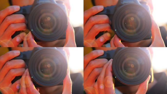 一个年轻人在日落时用相机拍摄的特写镜头