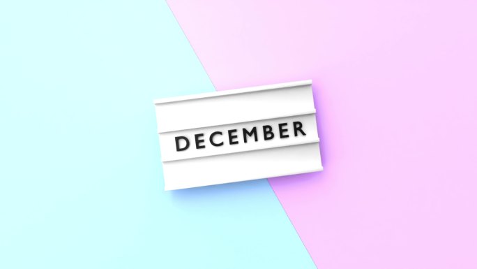 12月文本以4K分辨率显示在蓝色和粉红色背景的灯箱上