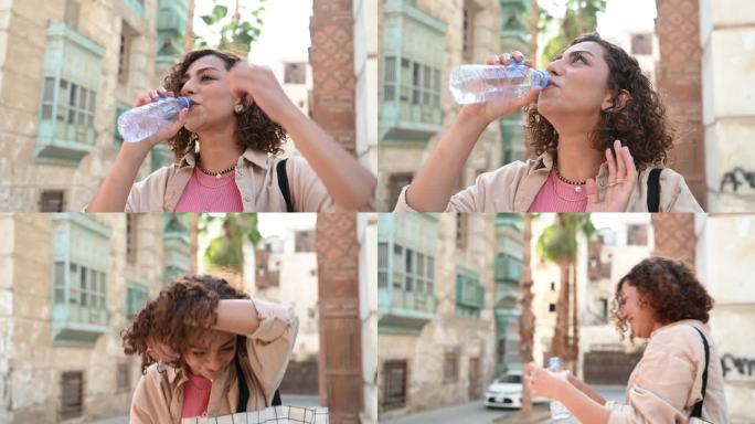 一位年轻沙特妇女饮用水的坦率特写