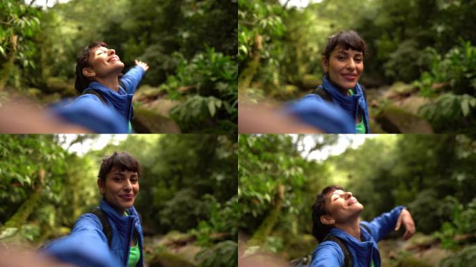 一个年轻的女人在森林里拍摄她自己的徒步旅行-摄像机的视角