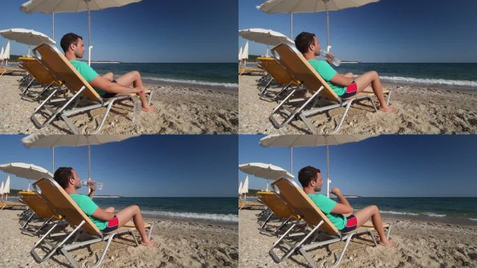 男子在海滩上饮水海边游玩