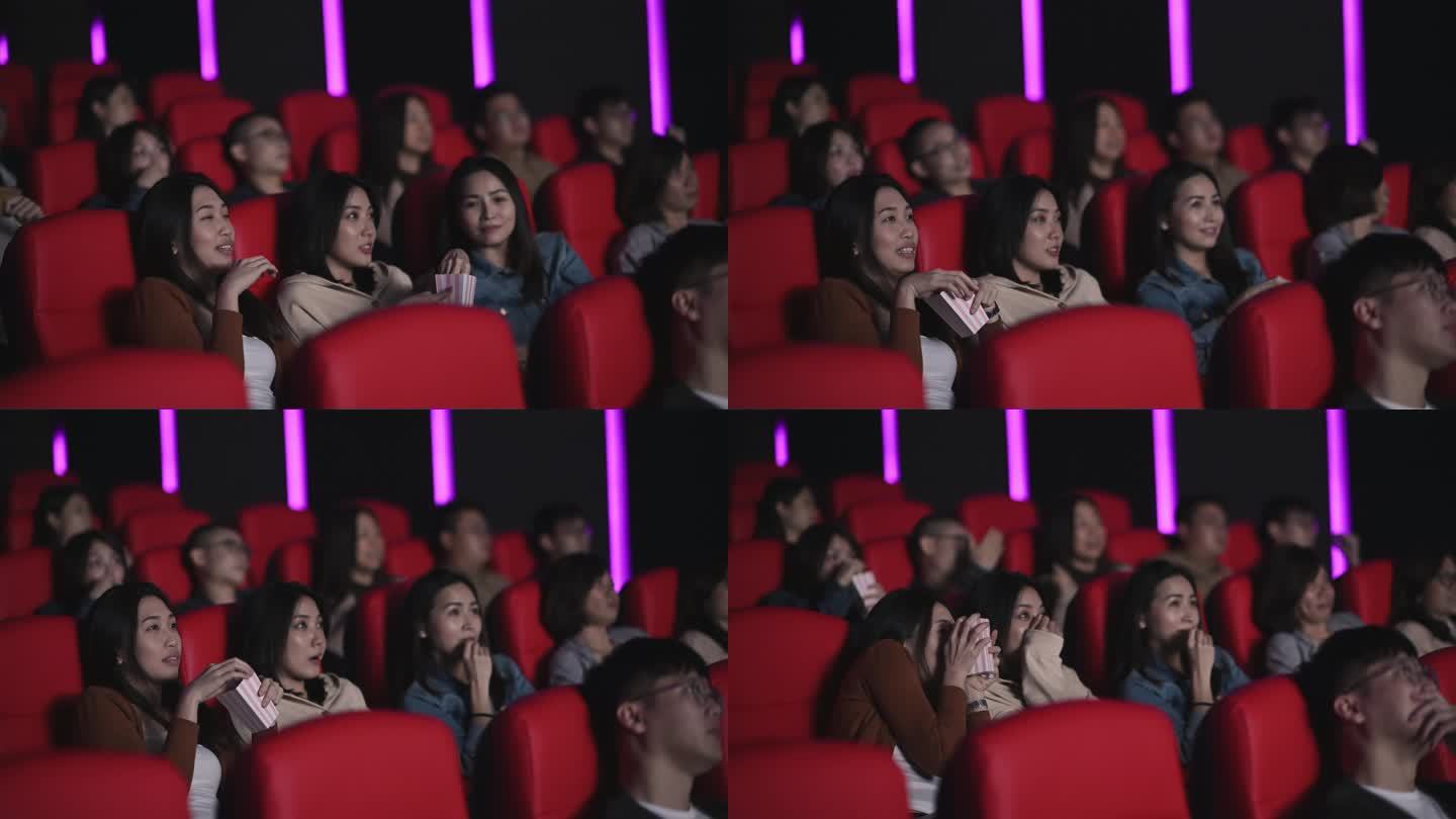 3名亚裔中国女性在电影院观看恐怖、恐怖、惊悚的电影，在电影院与其他观众一起遮盖脸部