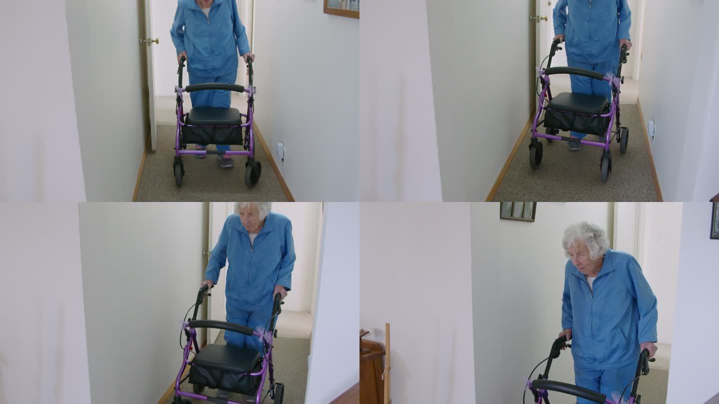 手持式拍摄的一名独立的老年妇女带着移动助行器穿过家中的走廊