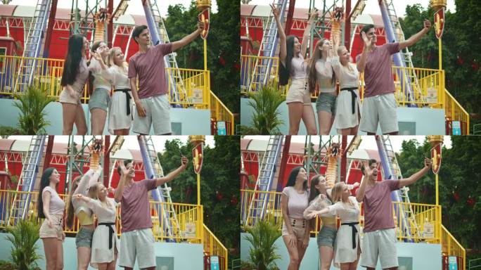 四个人在游乐园通过智能手机自拍的照片