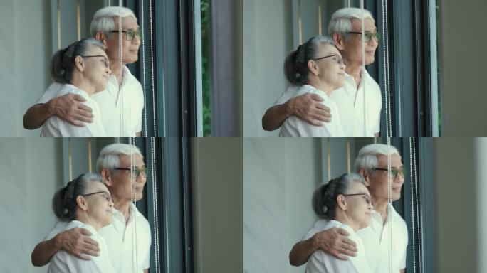 一对老年夫妇在家享受时光的4k视频片段，拥抱、微笑、福利退休夫妇肖像概念