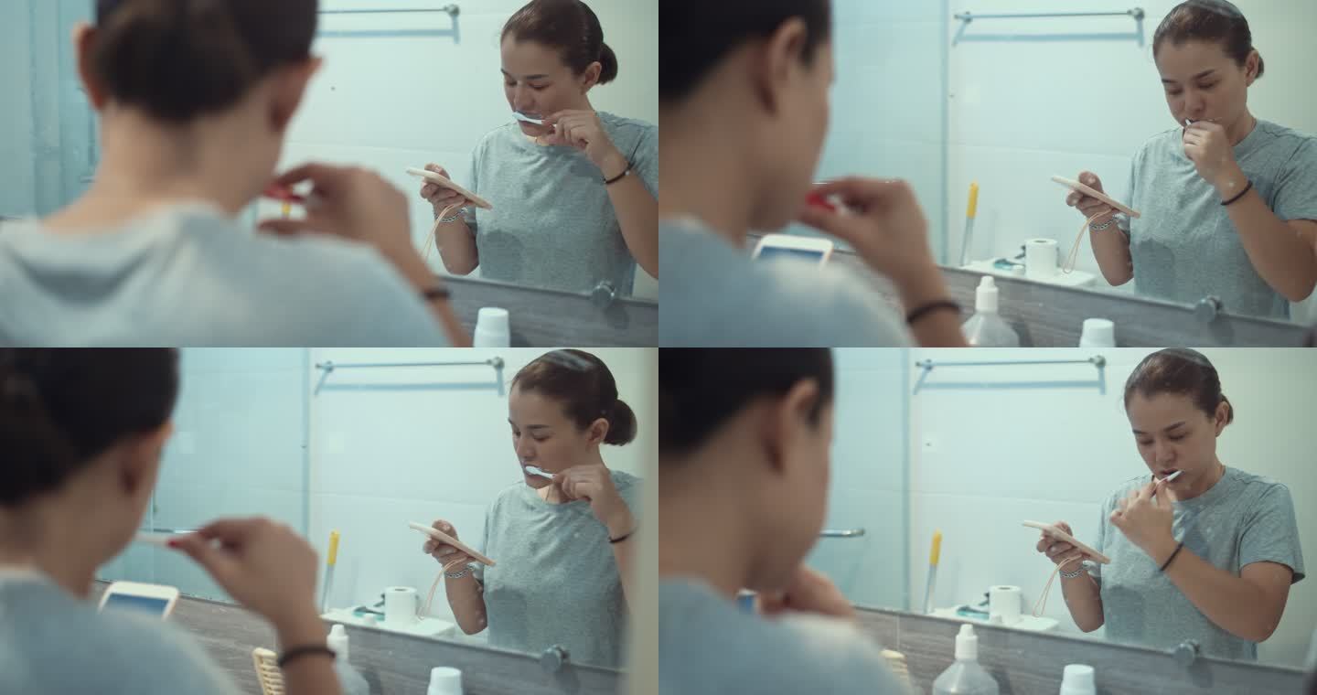 女性在浴室刷牙和使用智能手机