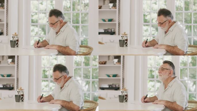 4k视频画面，一位英俊的老人在家里的厨房里检查一些文件