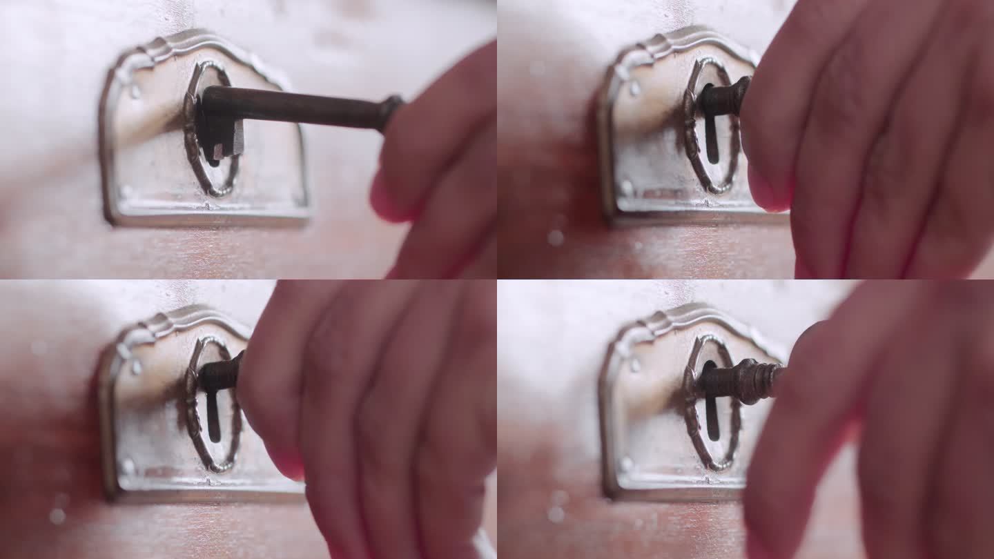 一只手用钥匙打开古代保险箱的特写镜头。