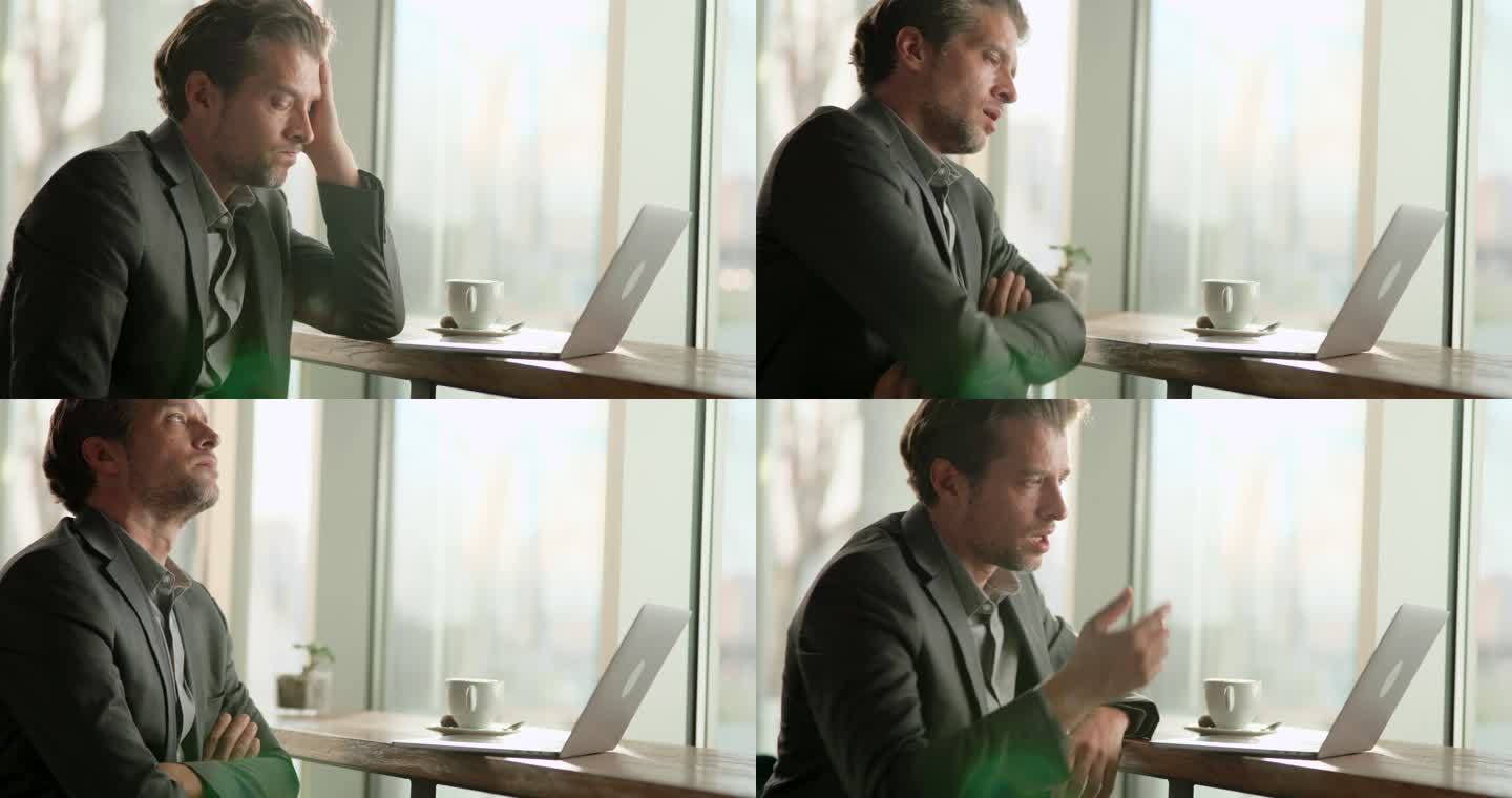 一位忧心忡忡的商人正在办公室的笔记本电脑上读一封电子邮件。