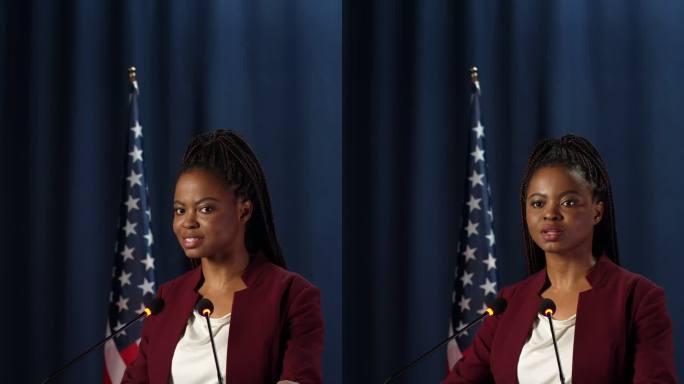 一位年轻、皮肤黝黑、自信的女政治家进入画面，在辩论中开始演讲