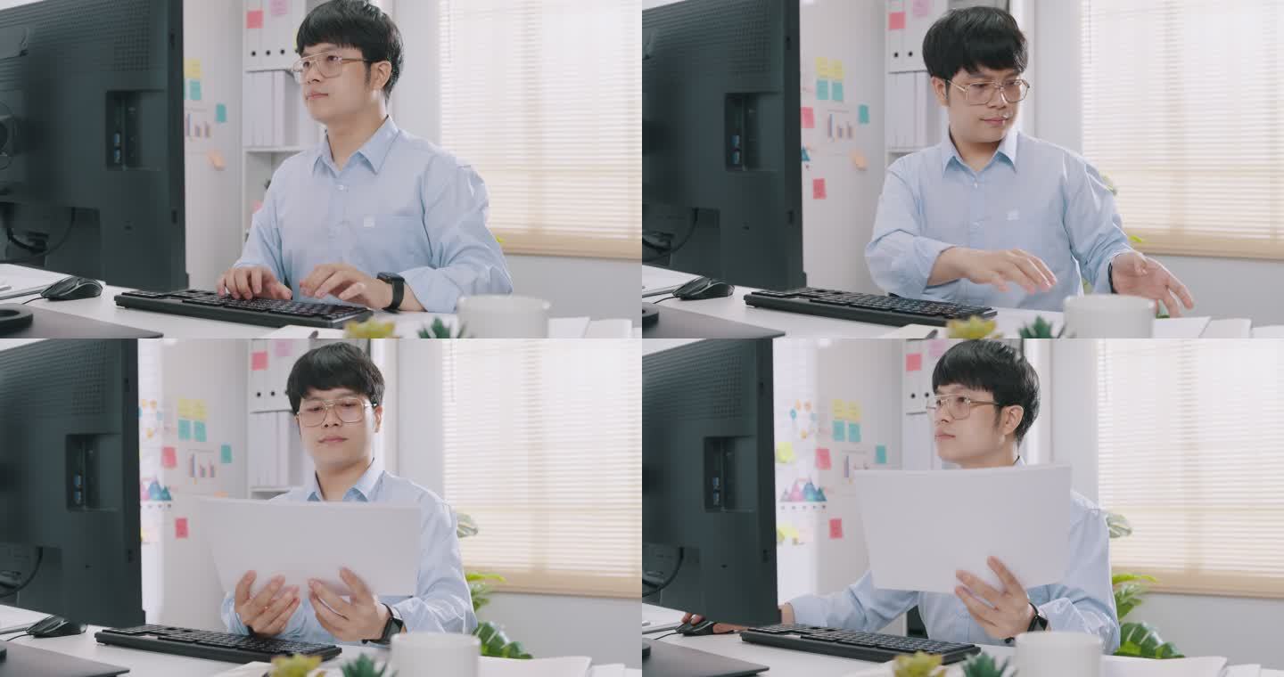 一位身穿蓝色正式衬衫的年轻亚洲商人坐在办公桌前，看着电脑打字，检查报告文件，在小办公室的会议板上展示