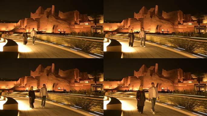 中年游客在夜间欣赏图拉伊夫遗址