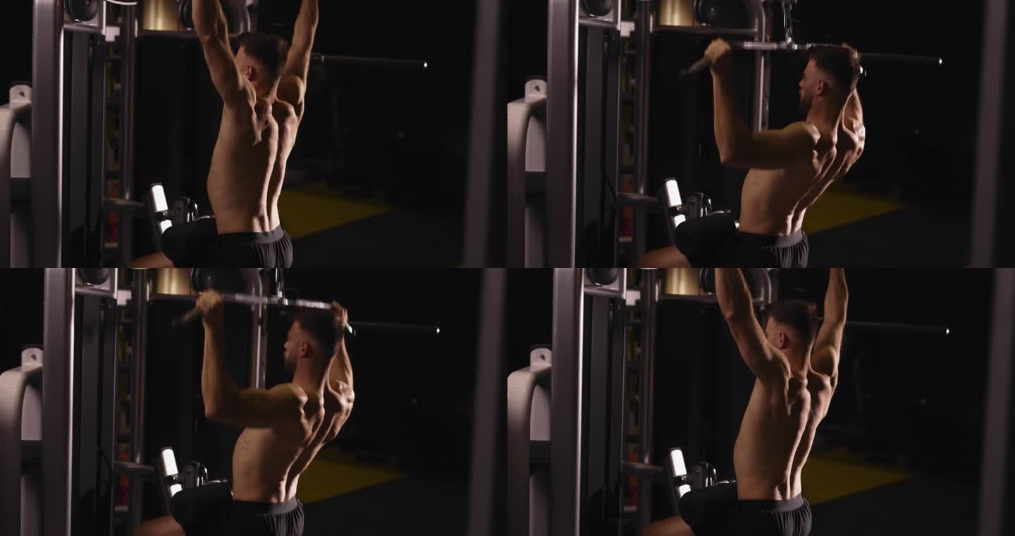 肌肉男健美运动员在健身房使用健身机锻炼