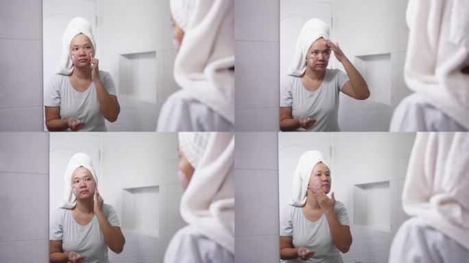 一个女人在镜子里涂保湿面霜