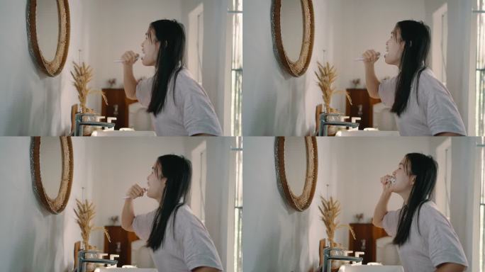 健康的女人早上刷牙。