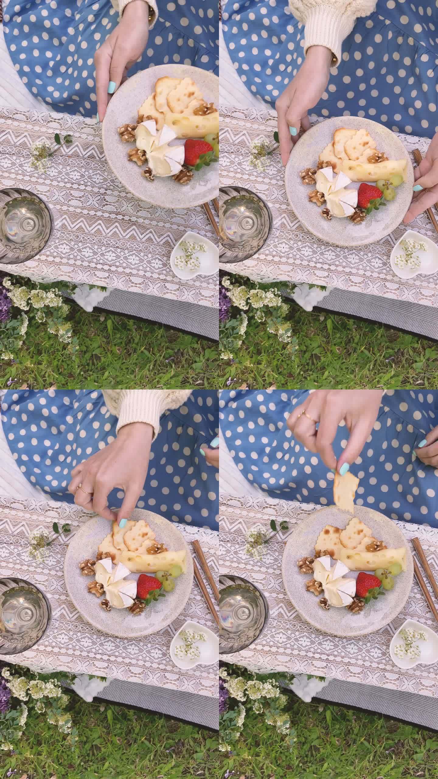 女人在装饰时尚的夏季野餐中吃饭-垂直视频